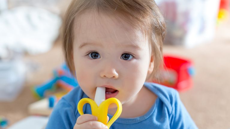 Toddler boy with a teething toy