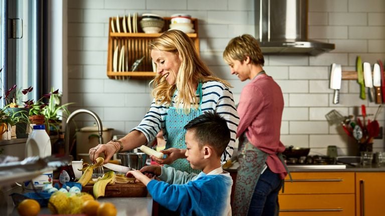  couple cooking with son in kitchen