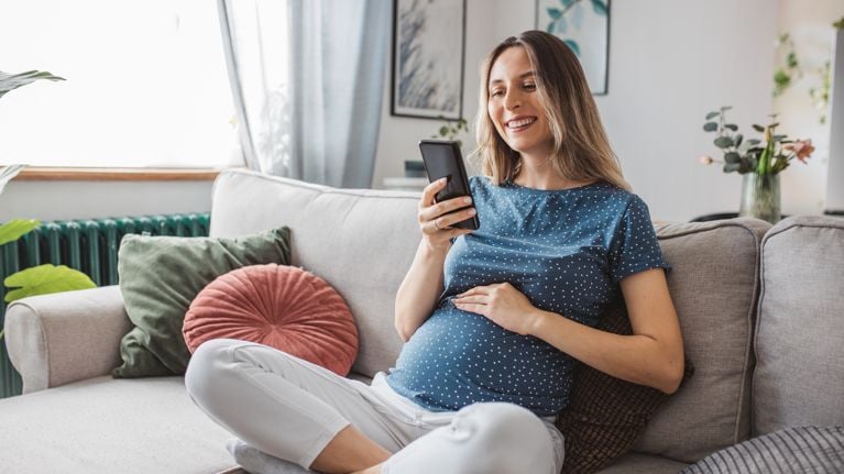pregnant woman sitting on couch