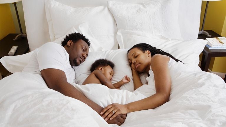 Baby co-sleeping with parents in bed