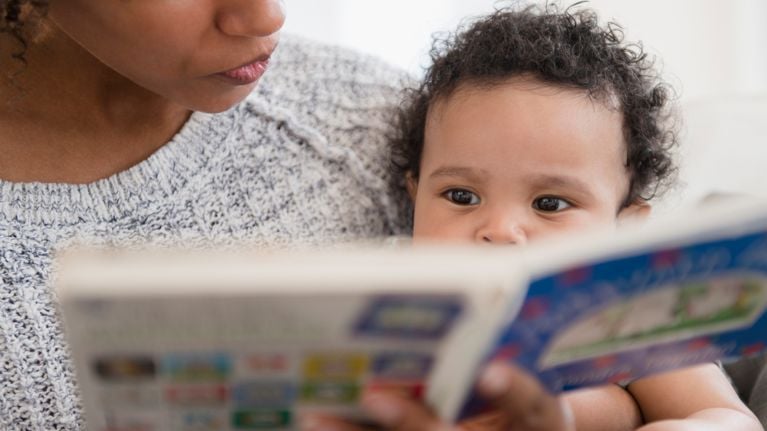 Mother reading book to baby son