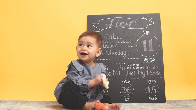 baby in front of chalkboard