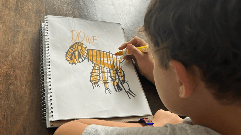 Author Nicole's son drawing a picture