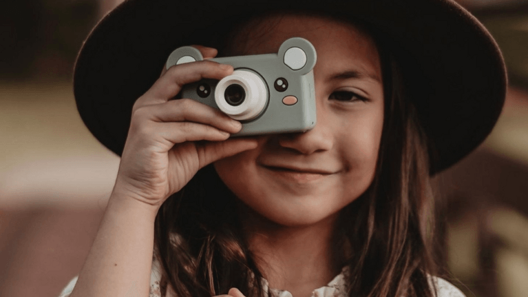 child holding up kidamento camera