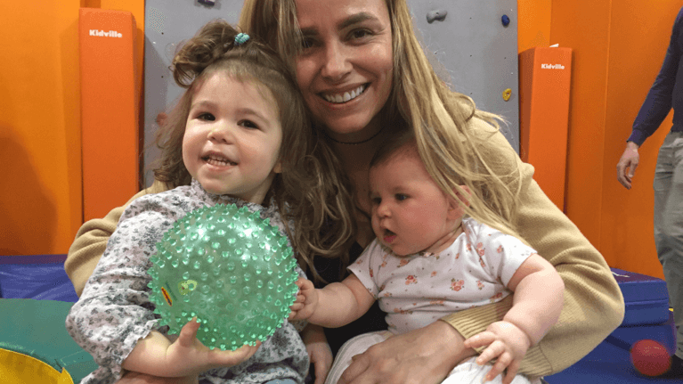 Author Kyla with her two young daughters at an indoor playground